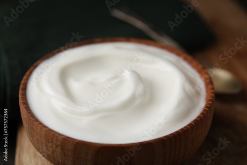 Delicious natural yogurt in bowl on table, closeup