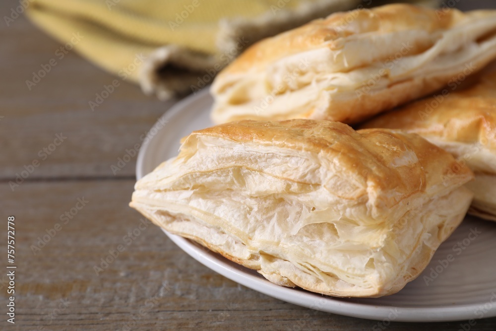 Delicious fresh puff pastries on wooden table, closeup. Space for text Delicious fresh puff pastries on wooden table, closeup. Space for text