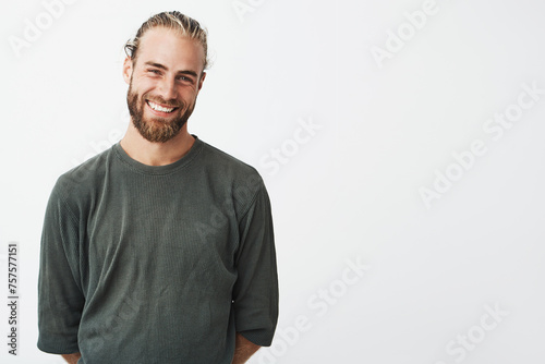 Portrait of cheerful handsome bearded guy with fashionable hairstyle smiling © Vitaly