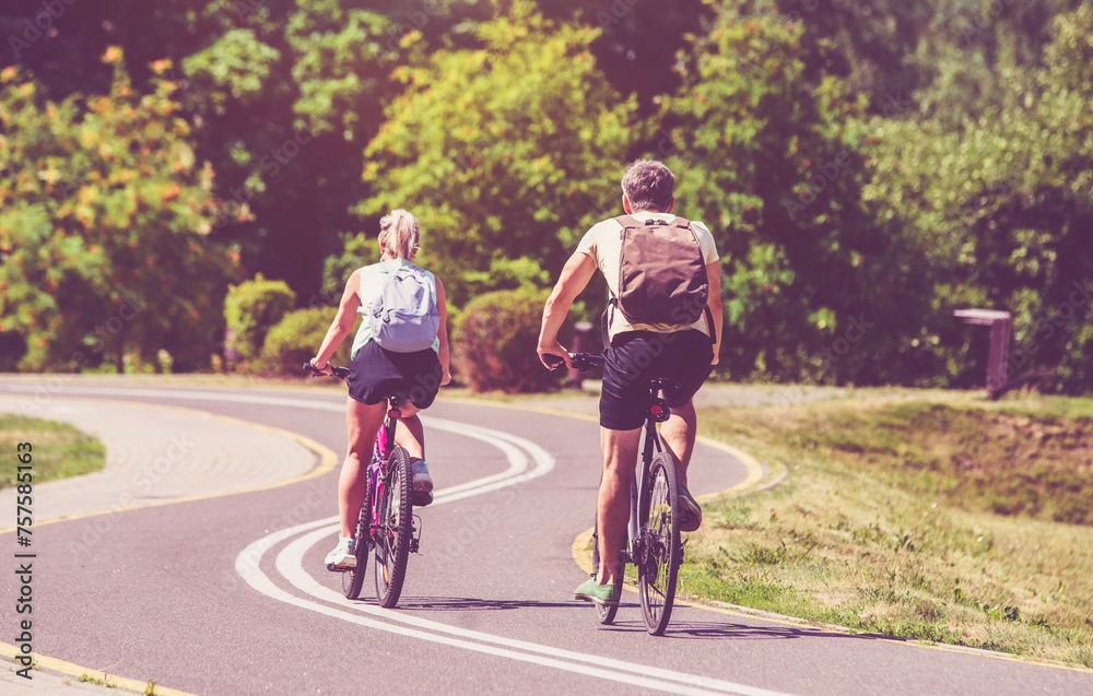 Cyclists ride on the bike path in the city Park
