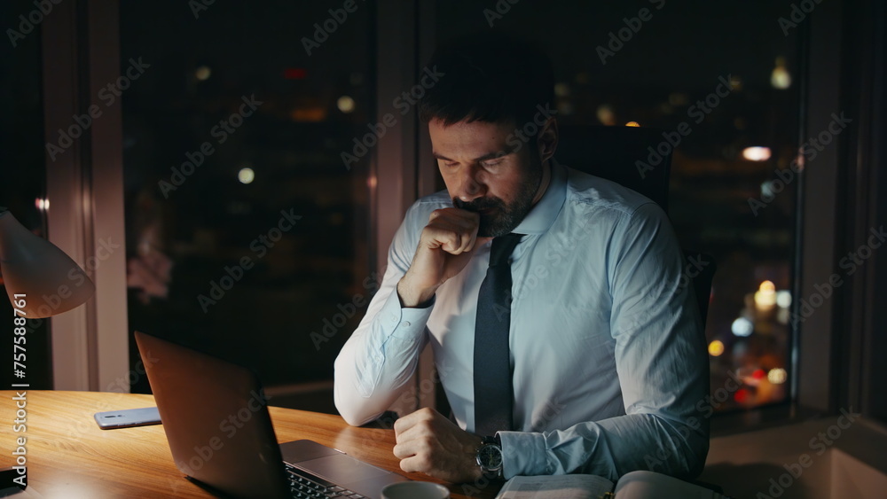 Anxious office manager working on laptop late evening closeup. Troubled employee Anxious office manager working on laptop late evening closeup. Troubled employee