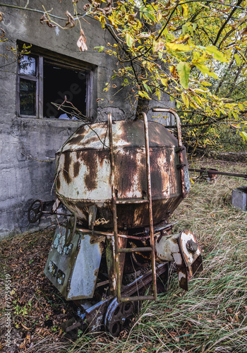 Old concrete mixer near abandoned Radioecology Laboratory in former fish farm in Chernobyl Exclusion Zone photo