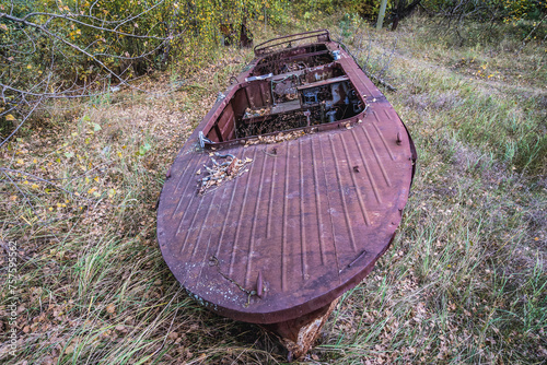 Rusty motorboat near abandoned Radioecology Laboratory in former fish farm in Chernobyl Exclusion Zone, Ukraine photo