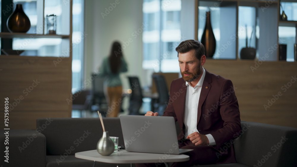Aggressive guy watching computer at coworking room. Businessman feeling furious Aggressive guy watching computer at coworking room. Businessman feeling furious