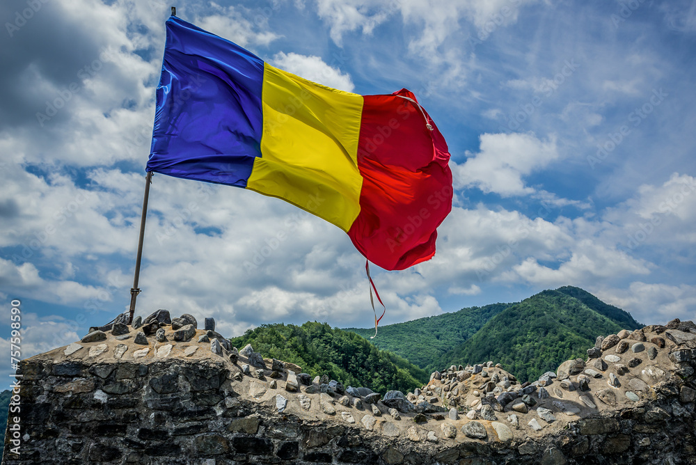 Romanian flag in ruined Poenari Castle on Mount Cetatea in Romania