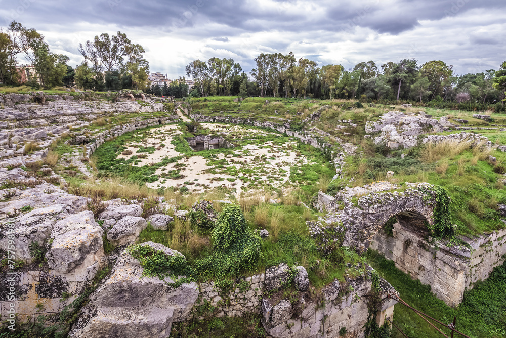 Remains of Roman Amphitheater in Neapolis archaeological park of Syracuse, Sicily Island in Italy
