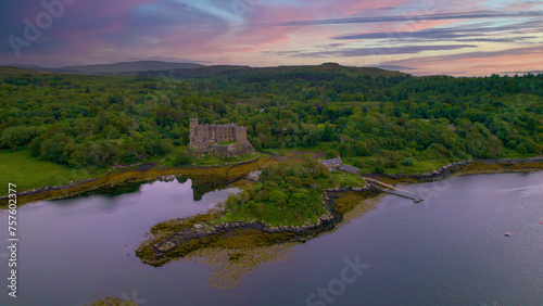AERIAL  Medieval Dunvegan Castle built on an elevated rock overlooking sea loch