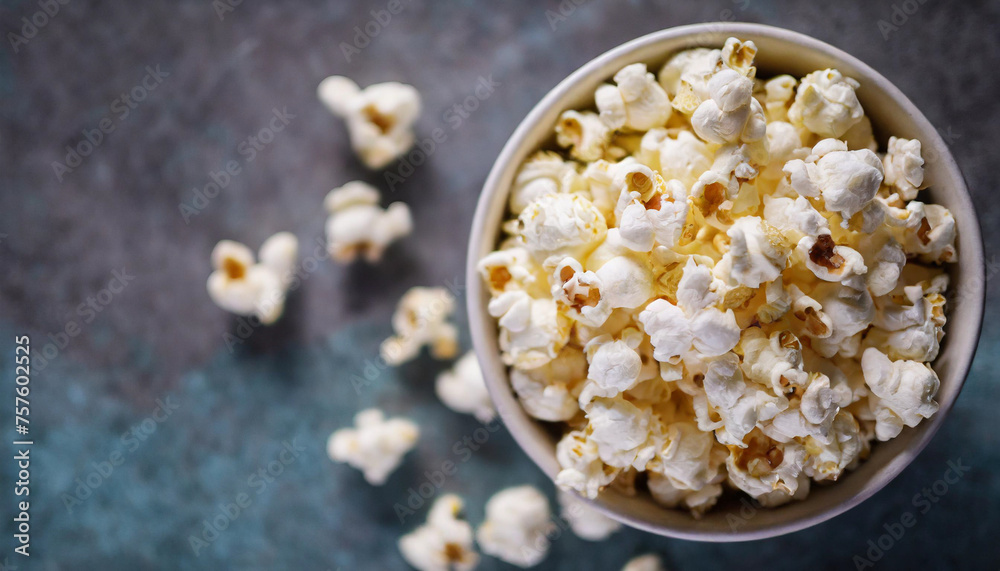 Nighttime snack scene with popcorn in bowl, symbolizing relaxation and indulgence. Top view, dark background Nighttime snack scene with popcorn in bowl, symbolizing relaxation and indulgence. Top view, dark background