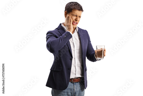 Man holding a glass of water and having a toothache photo