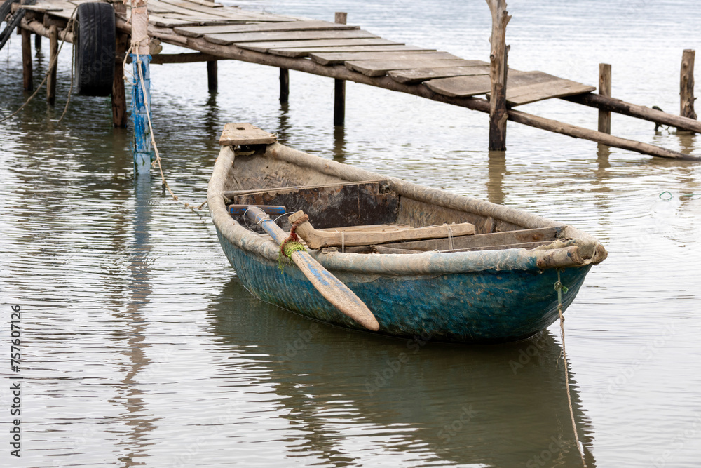 Fototapeta premium Traditional fishing boat in oyster farming industry in Lap An Lagoon, Vietnam