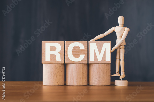 There is wood cube with the word RCM. It is an abbreviation for Risk Control Matrix as eye-catching image. photo