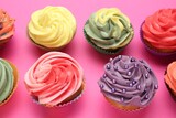 Delicious cupcake with bright cream on pink background
