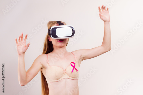 Girl in bra pink cancer ribbon and vr box
