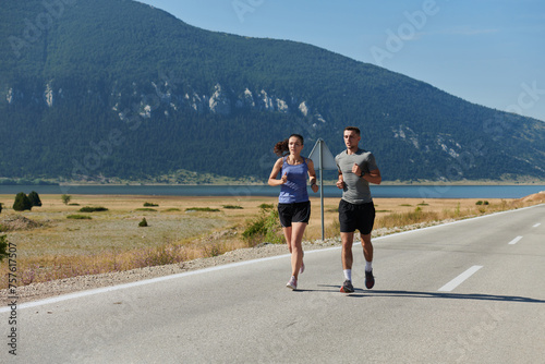 Energized by the beauty of nature, a couple powers through their morning run, their bodies and spirits invigorated.