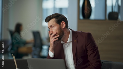 Disappointed businessman feeling sad about problems in work in office closeup