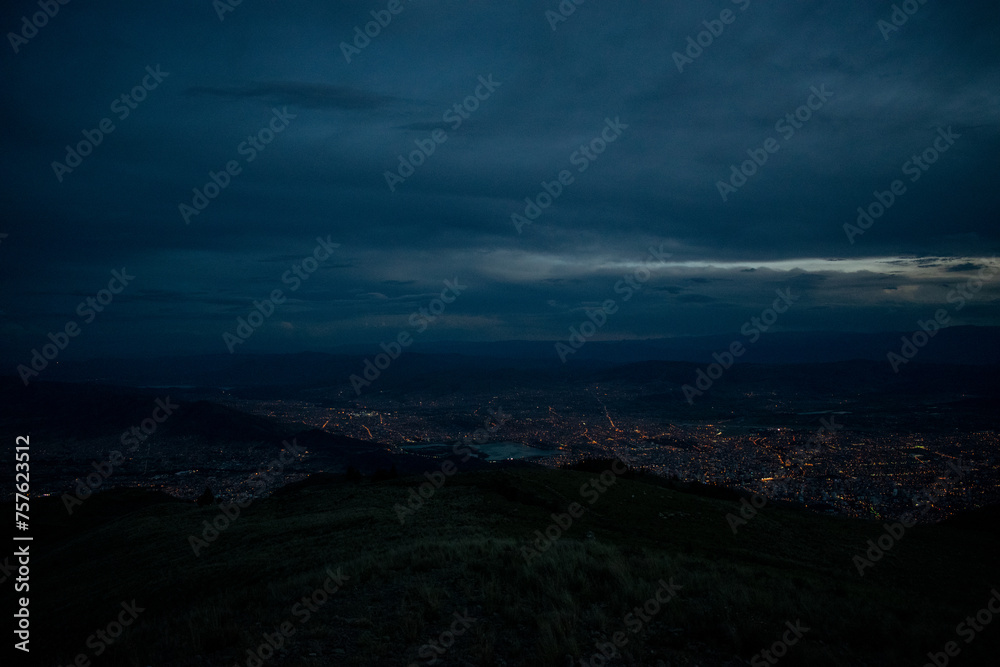 aerial landscape view of a sunset, with cloudy sky, from a mountain and a city in a valley. Cochabamba Bolivia