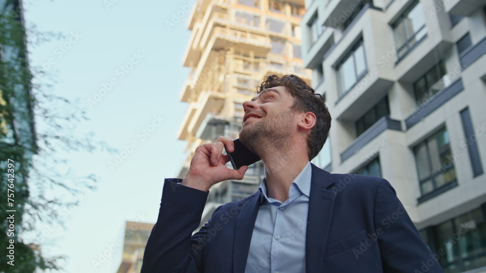 Happy man calling street modern residential area close up. Businessman talking Happy man calling street modern residential area close up. Businessman talking
