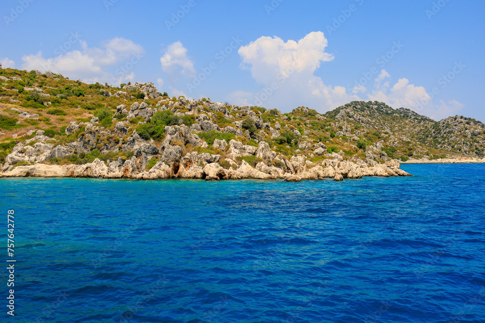View of the rocky shore from the sea. Mediterranean Sea in Turkey. Popular tourist places. Background