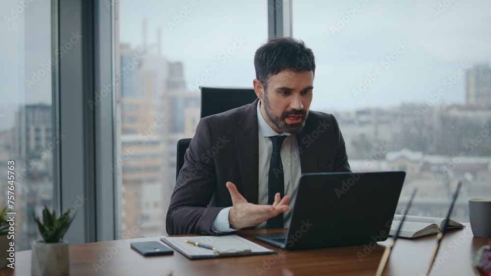 Nervous boss talking video meeting sitting office closeup. Manager videocalling Nervous boss talking video meeting sitting office closeup. Manager videocalling