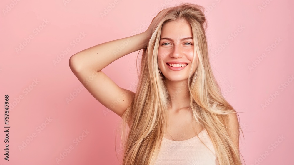 Smiling young woman with blonde long groomed hair isolated on pastel flat background with copy or text space, 16:9