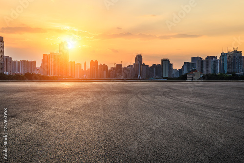  Asphalt road square and city skyline with modern buildings scenery at sunset