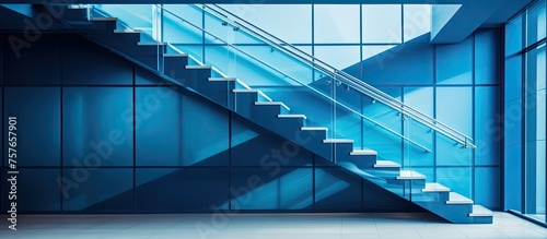 A stunning blue staircase, with a rectangular shape and aqua accents, stands as a striking fixture in a room filled with parallel windows