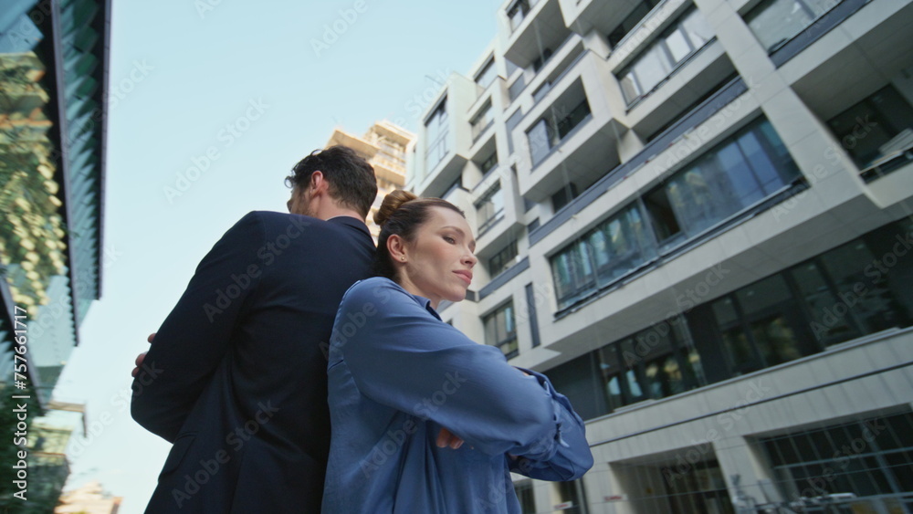 Business partners crossing hands posing at urban district. Colleagues standing Business partners crossing hands posing at urban district. Colleagues standing