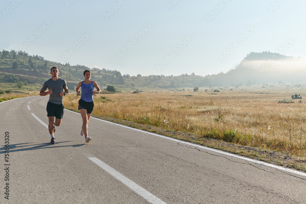 Energized by the beauty of nature, a couple powers through their morning run, their bodies and spirits invigorated. Energized by the beauty of nature, a couple powers through their morning run, their bodies and spirits invigorated.