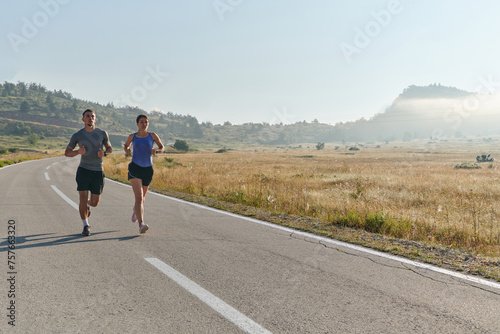 Energized by the beauty of nature, a couple powers through their morning run, their bodies and spirits invigorated. © .shock