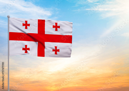 3D illustration of a Georgia flag extended on a flagpole and in the background a beautiful sky with a sunset