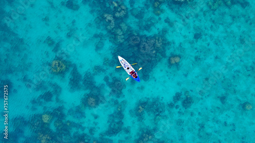Aerial view of a kayak in the blue sea .Woman kayaking She does water sports activities © Photo Sesaon
