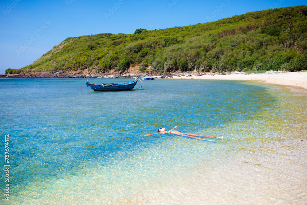 Woman on tropical beach. Girl swimming in sea Woman on tropical beach. Girl swimming in sea