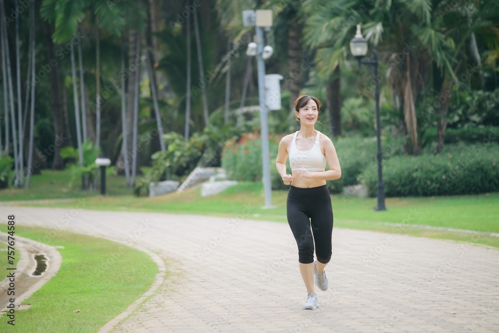 asian woman jogger running in green nature public park. asian woman jogger running in green nature public park.