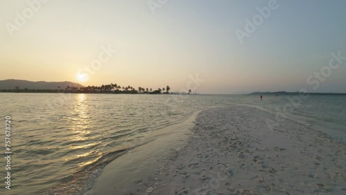 Wallpaper Mural Sunset over the beach with lazy waves and tropical island in the distance Torontodigital.ca