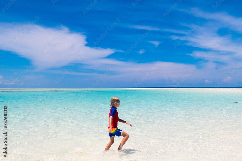 Kids playing on beach. Children play at sea.