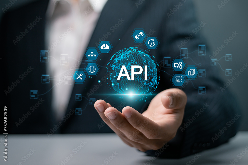 API, Application programing interface concept, software development tool, information technology. Businessman holding globe and API icon on virtual screen. - obrazy, fototapety, plakaty 