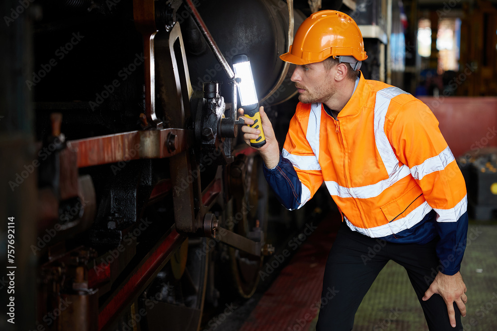 engineer or technician using light stick and checking construction train at station engineer or technician using light stick and checking construction train at station