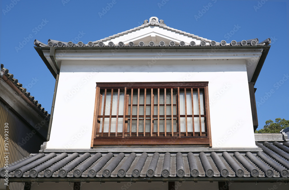 Second-floor room windows and traditional roof styles in an old Japanese town. Second-floor room windows and traditional roof styles in an old Japanese town.