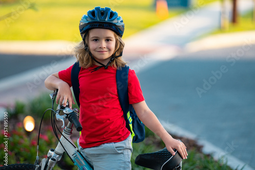 Little kid boy riding a bike in summer park. Child drive a bike on a driveway outside. Kid riding bikes in the city wearing helmets. Child on bike outdoor. Kid bicycling bike on american neighborhood.