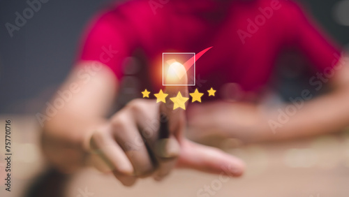 A person is pointing at a star rating system with a red background photo