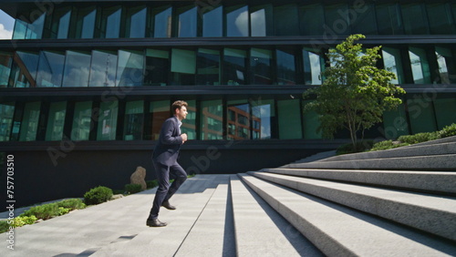 Confident man running stairs up urban street rushing to office. Boss hurrying  © stockbusters