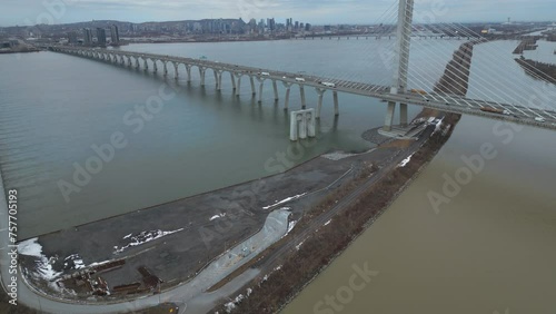 Reveal of downtown Montreal over Champlain Bridge and St-Laurent river photo