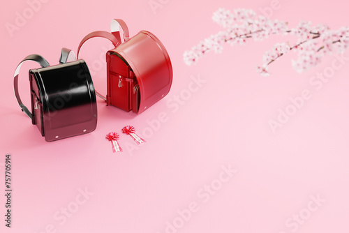 ピンクの背景に置かれた赤と黒のランドセルと桜の枝 / 入学式・春の新生活のコンセプトイメージ / コピースペース / 3Dレンダリング photo