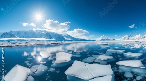 In this vibrant image, the warmth of the sun kisses the icy surface, with glistening ice floes floating atop the Arctic waters. 