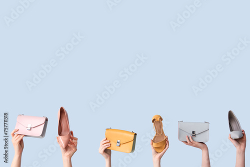 Women with stylish shoes and bags on light background