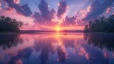 Soft clouds in shades of pink and lavender are mirrored in the still waters of the lake creating a picturesque sunset scene