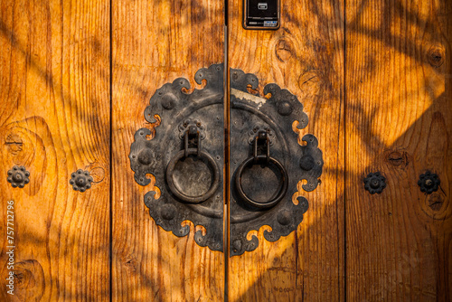 Traditional Korean style iron handle of old wooden door (vintage style) at Bukchon Hanok Village in Seoul, South Korea. in Seoul, South Korea