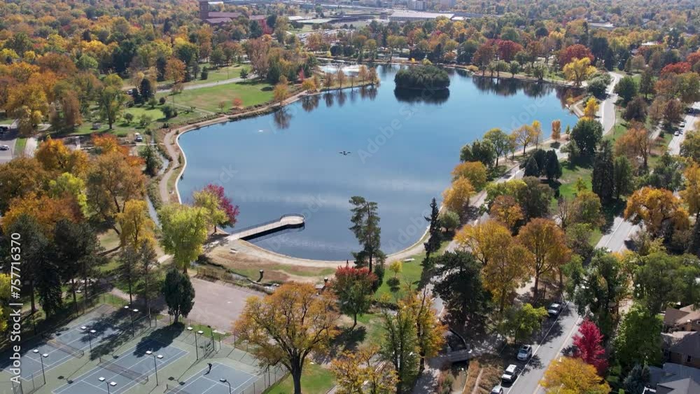 A 4K drone shot over Washington Park and Tennis Courts, Mount Vernon Garden, and Grasmere Lake, in Denver, Colorado, on a peaceful day, during the colorful Fall season. A 4K drone shot over Washington Park and Tennis Courts, Mount Vernon Garden, and Grasmere Lake, in Denver, Colorado, on a peaceful day, during the colorful Fall season.
