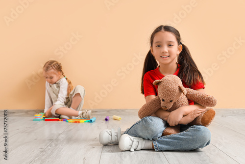 Little girls with toys near...