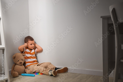 Stressed little boy with au...
